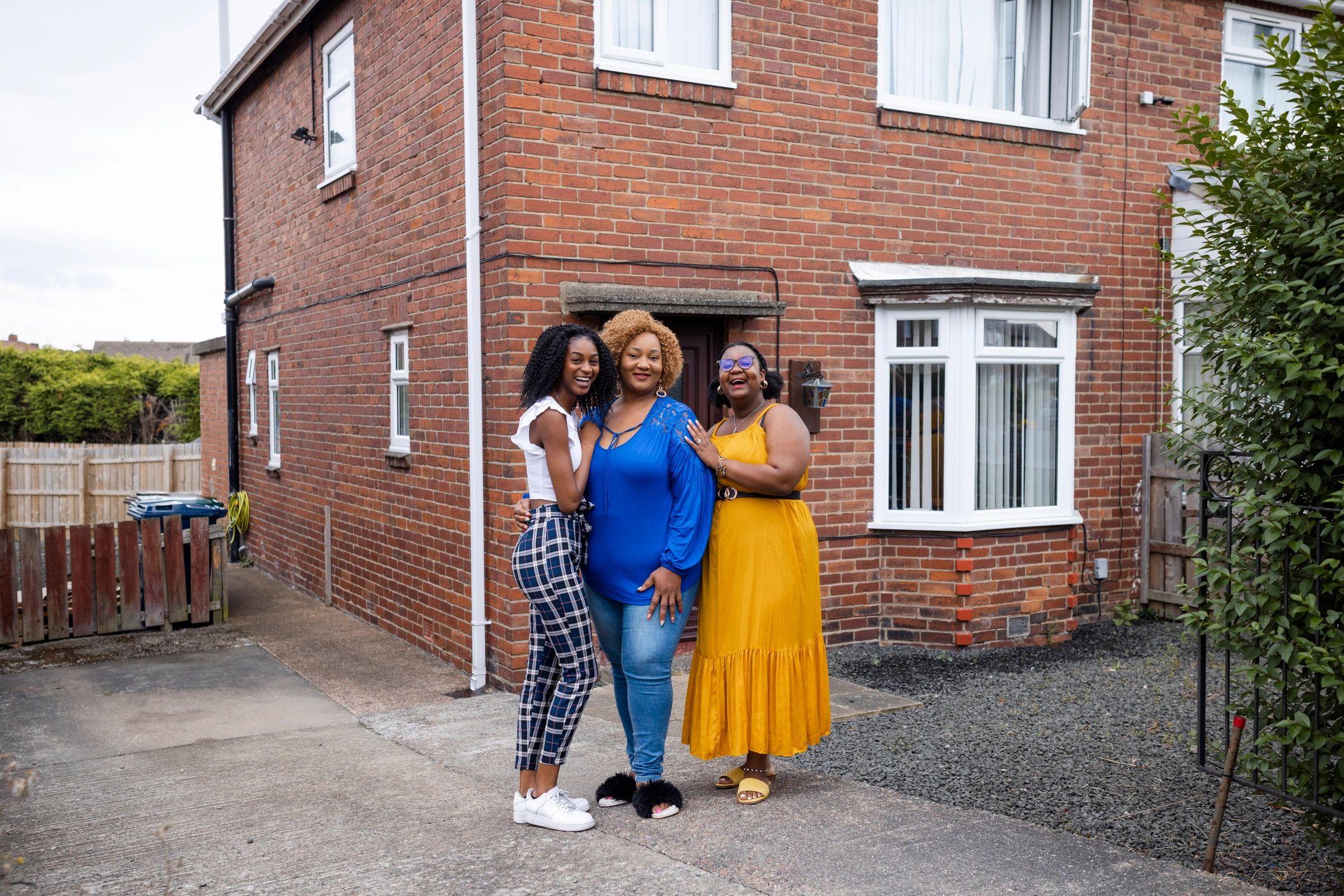 Family outside their home in a comfortable residential setting