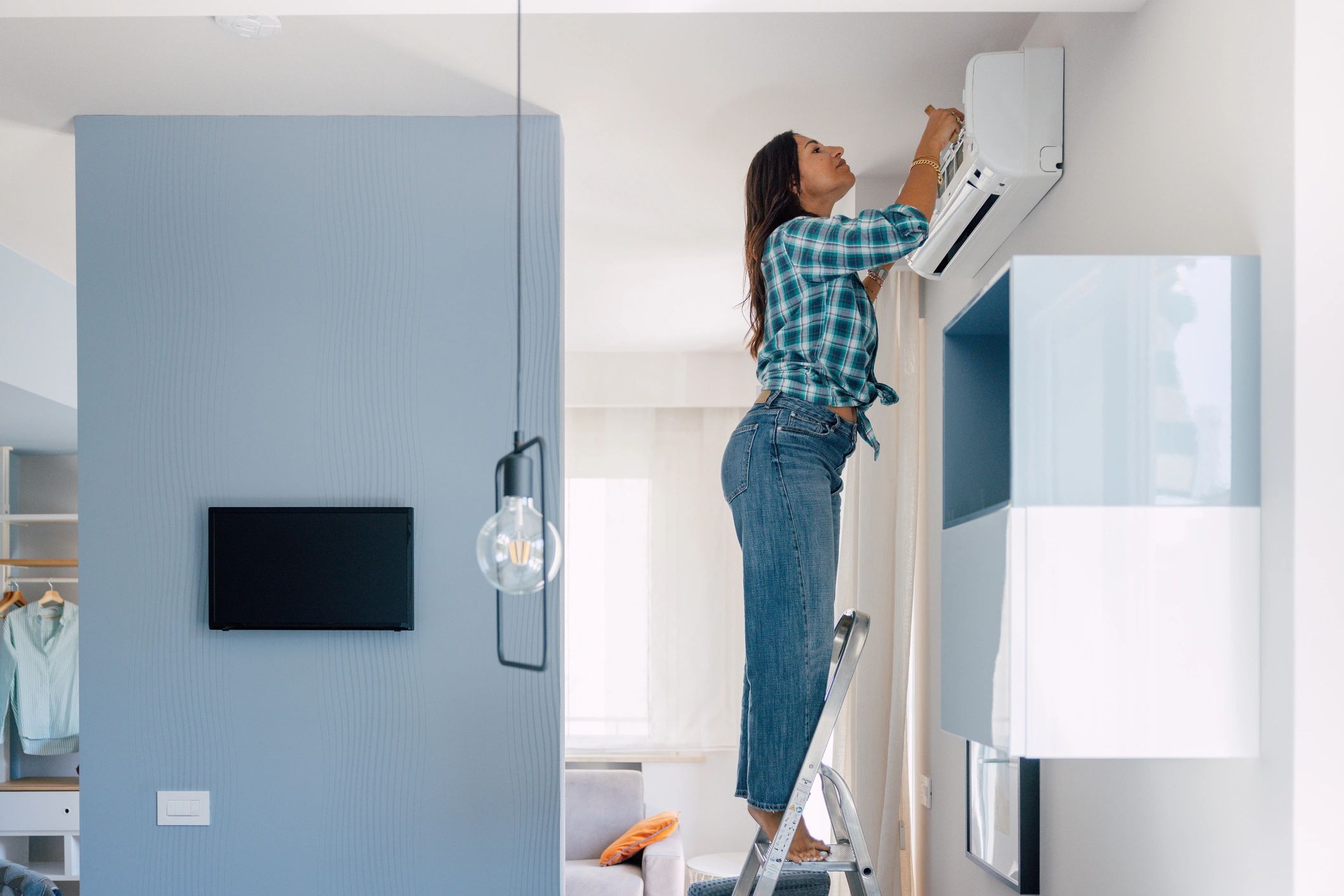 Technician servicing a home air conditioning unit
